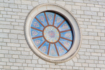 Fototapeta na wymiar The colorful mosaic window on the Church