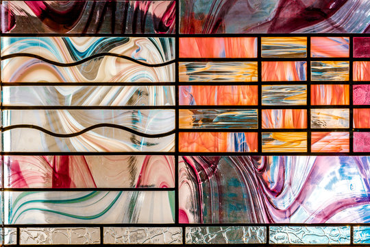 image of a multicolored stained glass window with an irregular block pattern, an abstract pattern on the glass, a trend, a multicolored geometric background