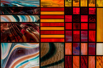 image of a multicolored stained glass window with an irregular block pattern, an abstract pattern...