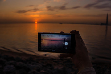Fototapeta premium The hand is holding smartphone