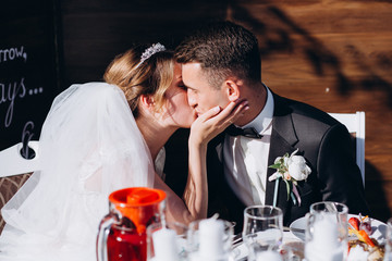 Newlyweds at the wedding table. Congratulation of the newlyweds at the wedding table.