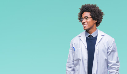 Afro american doctor scientist man over isolated background looking away to side with smile on...