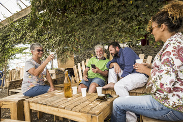 caucasian family in relationship and friendship sitting outdoor in a natural place made with...