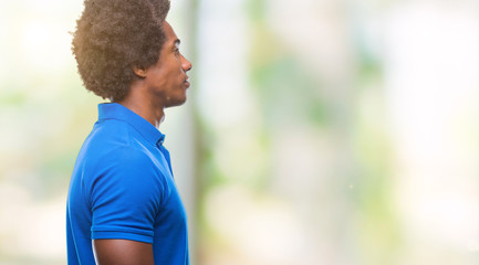 Afro american man over isolated background looking to side, relax profile pose with natural face with confident smile.