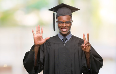 Young graduated african american man over isolated background showing and pointing up with fingers number seven while smiling confident and happy.