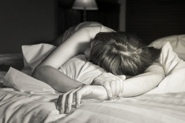 Sad woman on bed,black and white color.