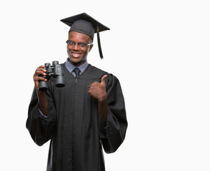 Young graduated african american man looking for a job using binoculars happy with big smile doing ok sign, thumb up with fingers, excellent sign