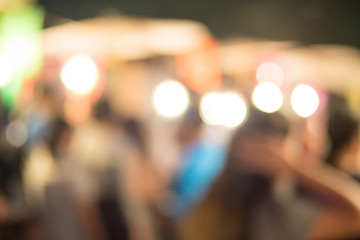 abstract blur image of food stall at night festival with bokeh for background usage