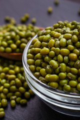 fresh Mung beans on a dark stone background