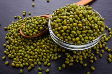 fresh Mung beans on a dark stone background
