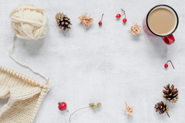 Background with knitting, red mug with hot drink and decoration