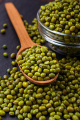 fresh Mung beans on a dark stone background
