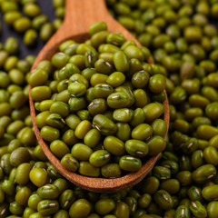 fresh Mung beans on a dark stone background