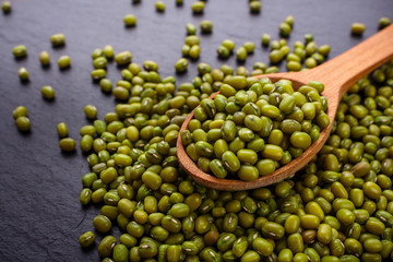 fresh Mung beans on a dark stone background