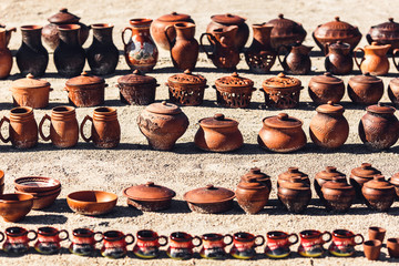 Ukrainian pottery is on sand on sunny day.