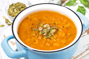 healthy lunch. spicy pumpkin soup in a saucepan, closeup