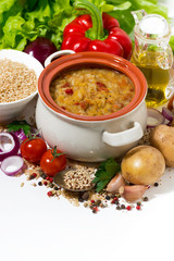 healthy soup with lentils and vegetables on a white background, top view vertical