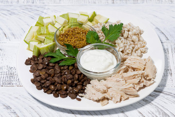 ingredients for a healthy lunch. chicken, lentils, vegetables and cereals