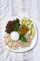 ingredients for a healthy lunch. chicken, lentils, vegetables and cereals, vertical