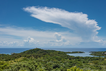 Cumulonimbus Anvil Cloud Over Caribbean Sea and Green Landscape Foreground