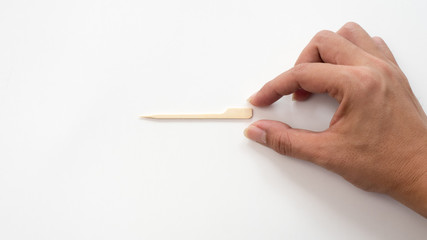 Toothpick on white background with hand