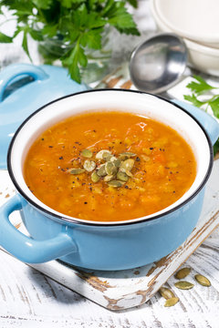 healthy lunch. spicy pumpkin soup in a saucepan, vertical closeup
