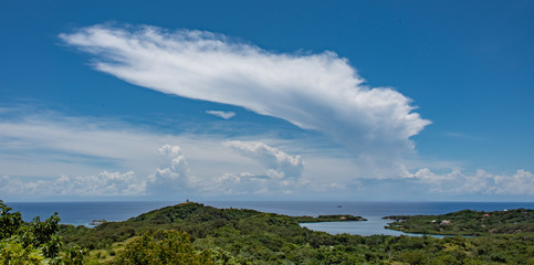 Cumulonimbus Anvil Cloud Over Caribbean Sea and Green Landscape Foreground