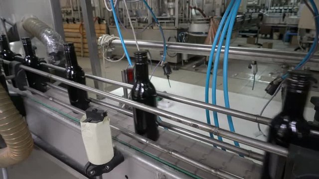 Bottling and sealing conveyor line at winery factory