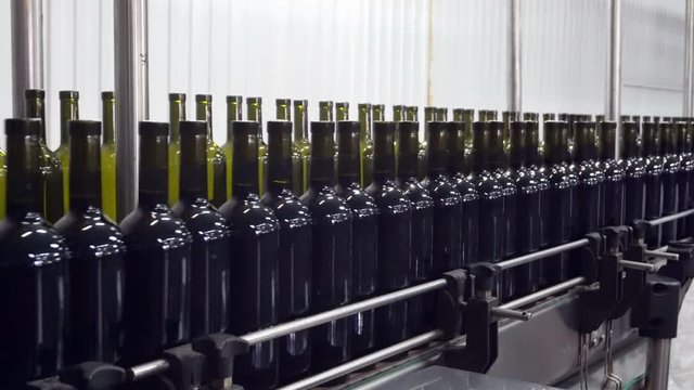 Bottling and sealing conveyor line at winery factory