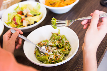 Female eating pasta in the restaurant