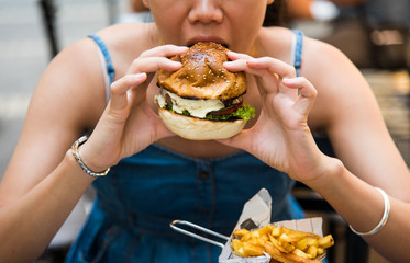 Girl eating burger in the restaurant