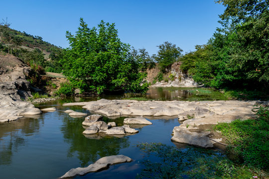 flowing through the forest, a quiet stony and rocky river. beautiful view of nature. Azerbaijan Lerik