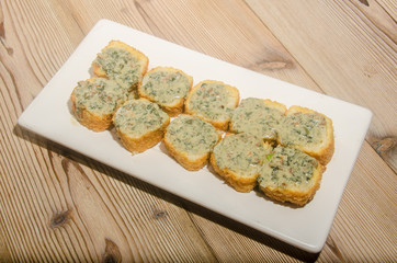 Weathered sushi roll with rockefeller sauce