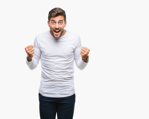 Young handsome man over isolated background celebrating surprised and amazed for success with arms raised and open eyes. Winner concept.