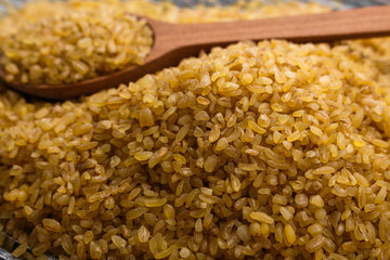 raw bulgur on a rustic wooden background