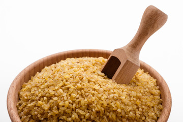 raw bulgur on a white acrylic background