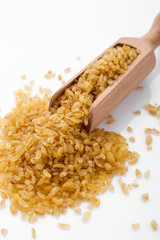 raw bulgur on a white acrylic background