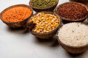 cereals, seeds, beans, grains in a bowls on white table