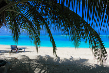 Lounge chair on the white sandy beach