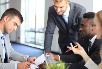 Businessman smiling happily as his business partner finally signing important contract.