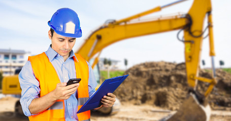 Engineer talking at the phone in a construction site