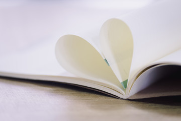 Heart shape paper book on wood table