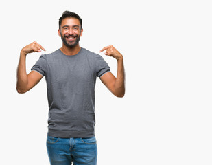 Adult hispanic man over isolated background looking confident with smile on face, pointing oneself...