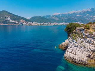 aerial view of rocky cliff with blue sea water.