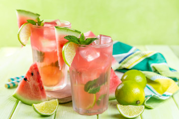 Watermelon lemonade with lime and mint, wood background, copy space