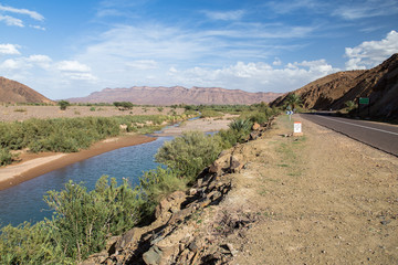 Mountain road along a river in the Atlas mountains of Morocco