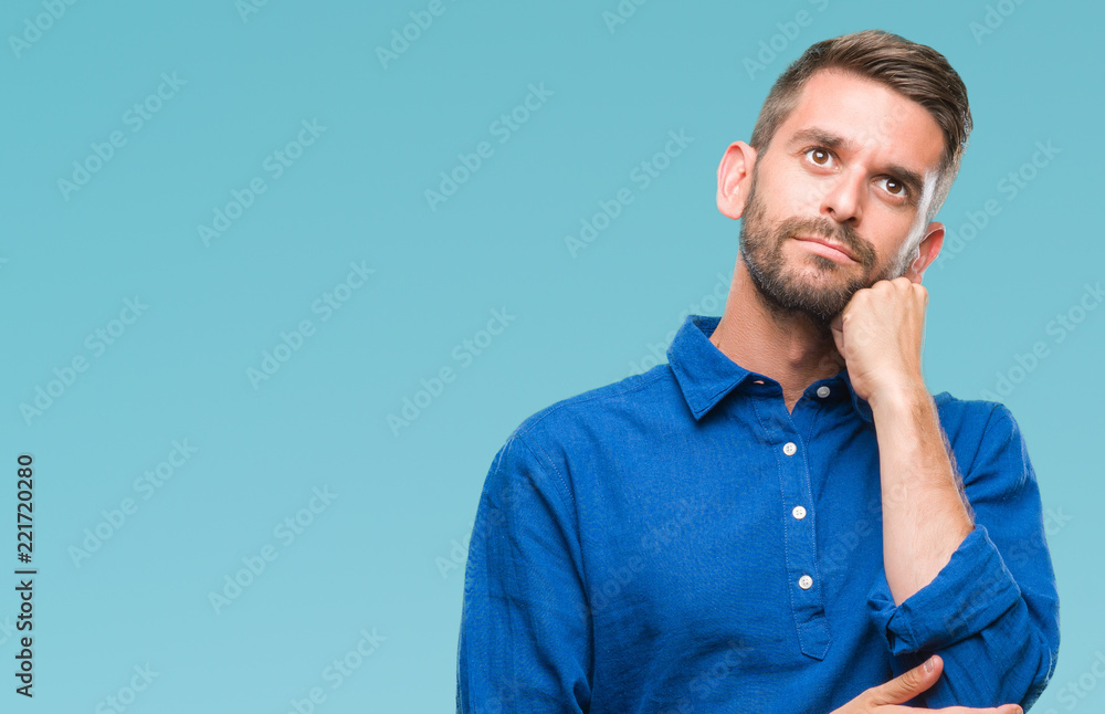 Sticker Young handsome man over isolated background with hand on chin thinking about question, pensive expression. Smiling with thoughtful face. Doubt concept.