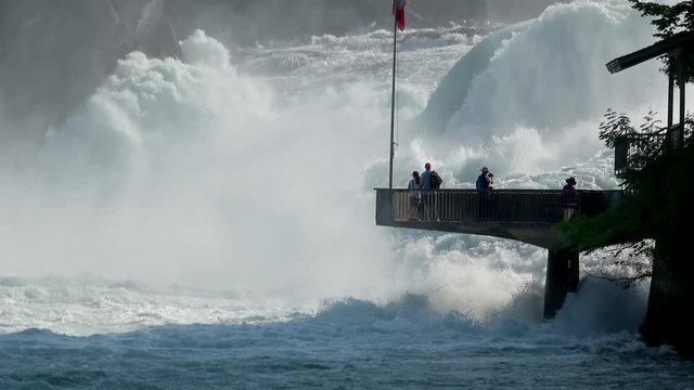 View waterfall the Rhine Falls (Rheinfalls) in Schaffhausen, Switzerland. The Rhine Falls is the largest waterfall in Europe. Summer landscape, sunshine weather and sunny day