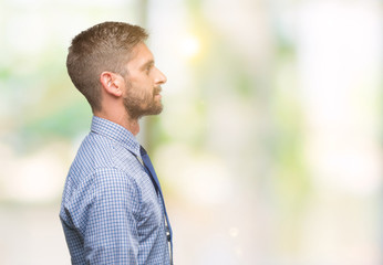 Young handsome business man over isolated background looking to side, relax profile pose with natural face with confident smile.