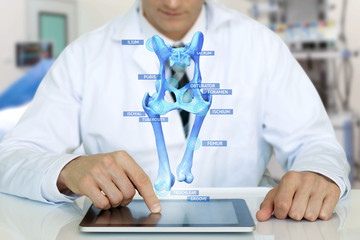 Smart health care internet of things and  augmented reality education , Artificial intelligence hologram bone bone structure technology concept. Doctor using tablet with ar application popup screen.